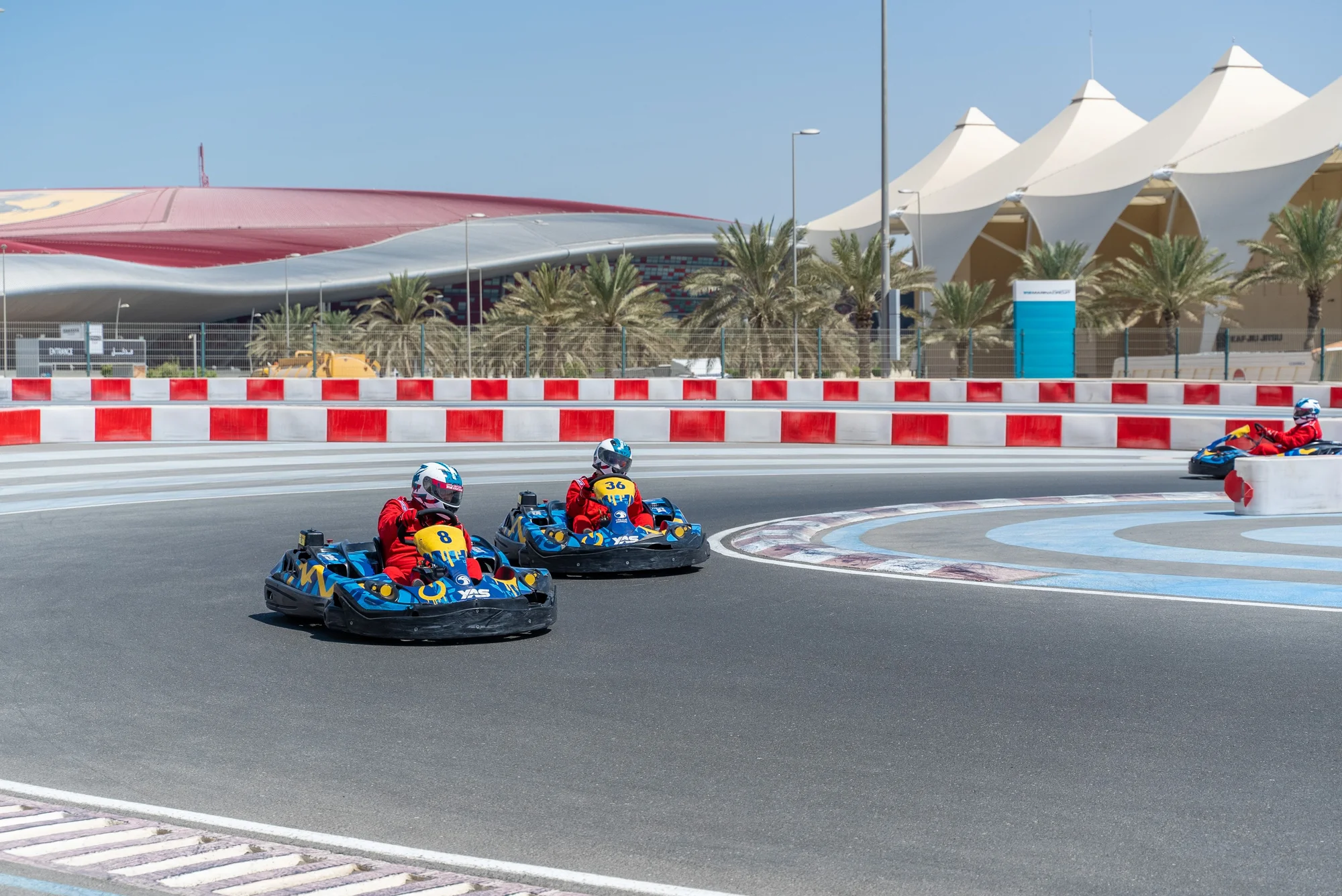 Racing karts near Ferrari World Abu Dhabi on a sunny day.