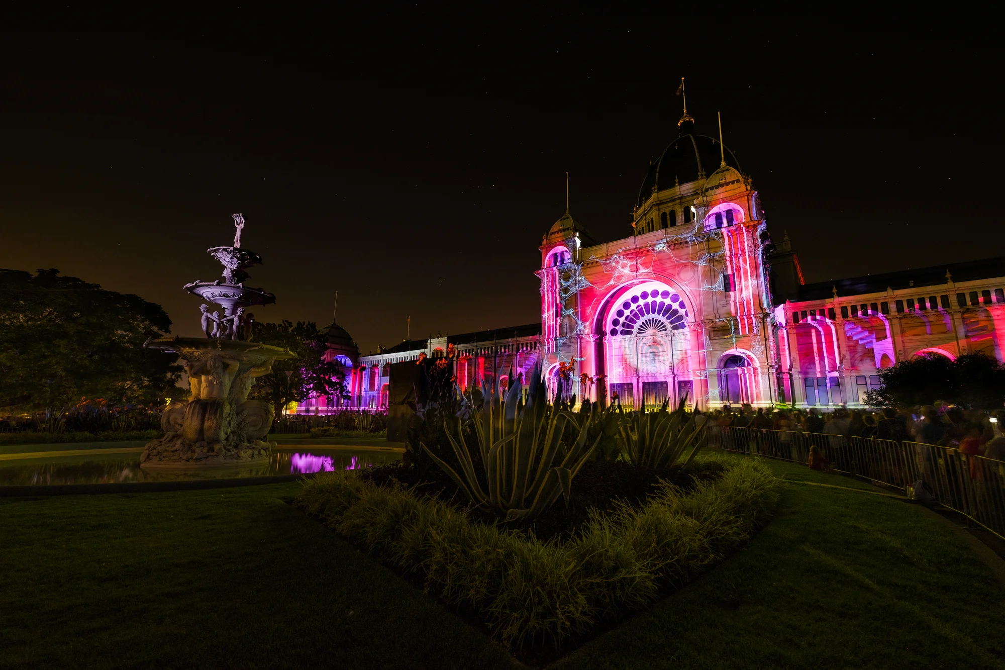 Royal Exhibition Building illuminated at night, Melbourne, vibrant image with bright colors.