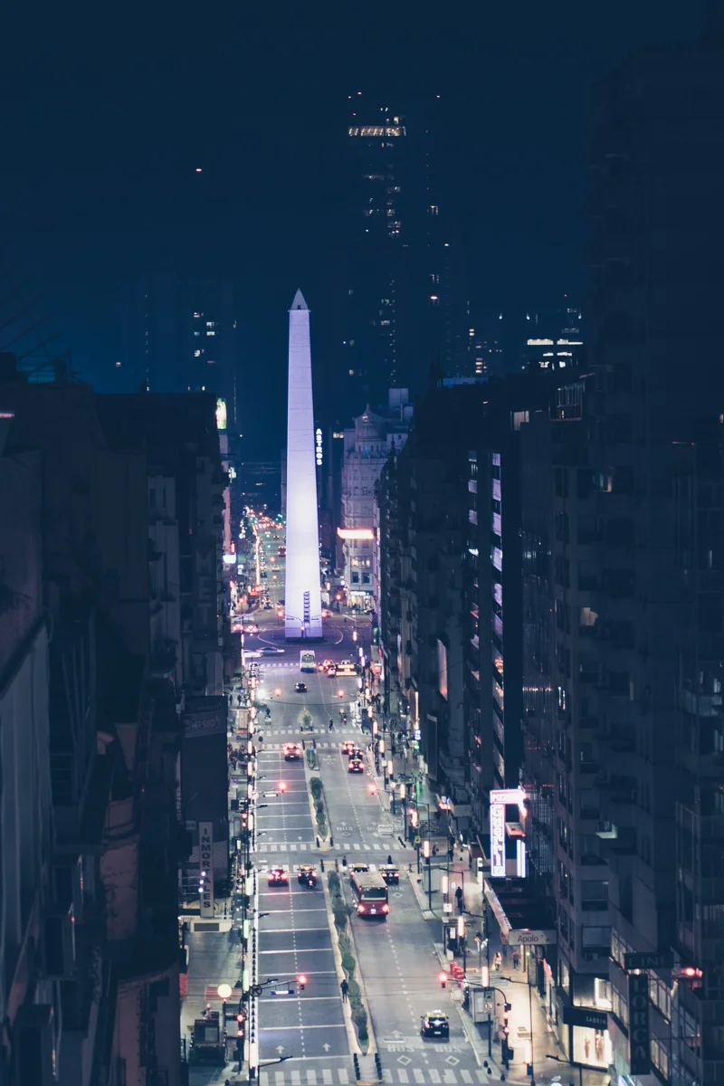 Obelisco de Buenos Aires lit up at night, panoramic urban view.