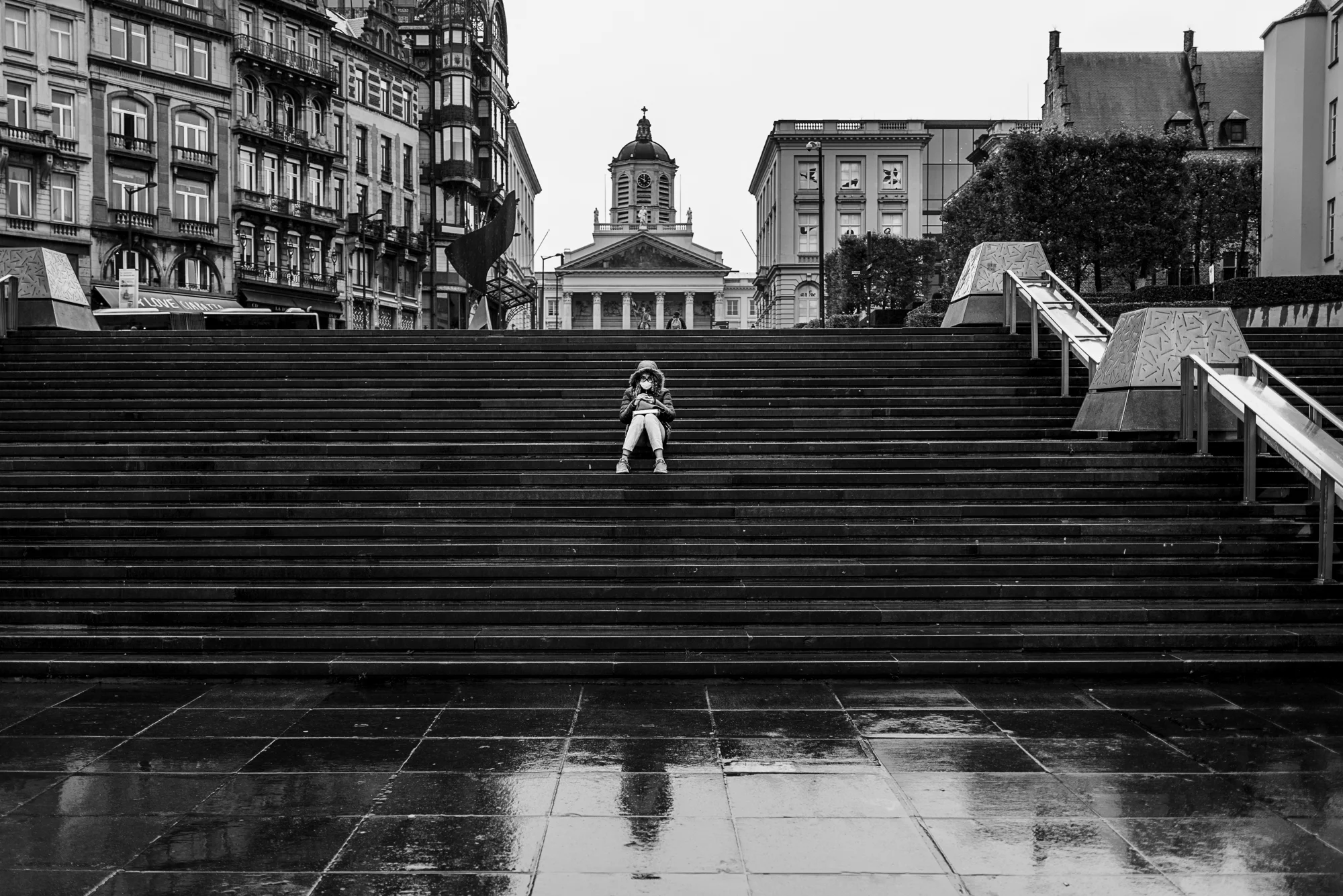 Black-and-white image of the Mont des Arts steps in Brussels with historic buildings in the background.