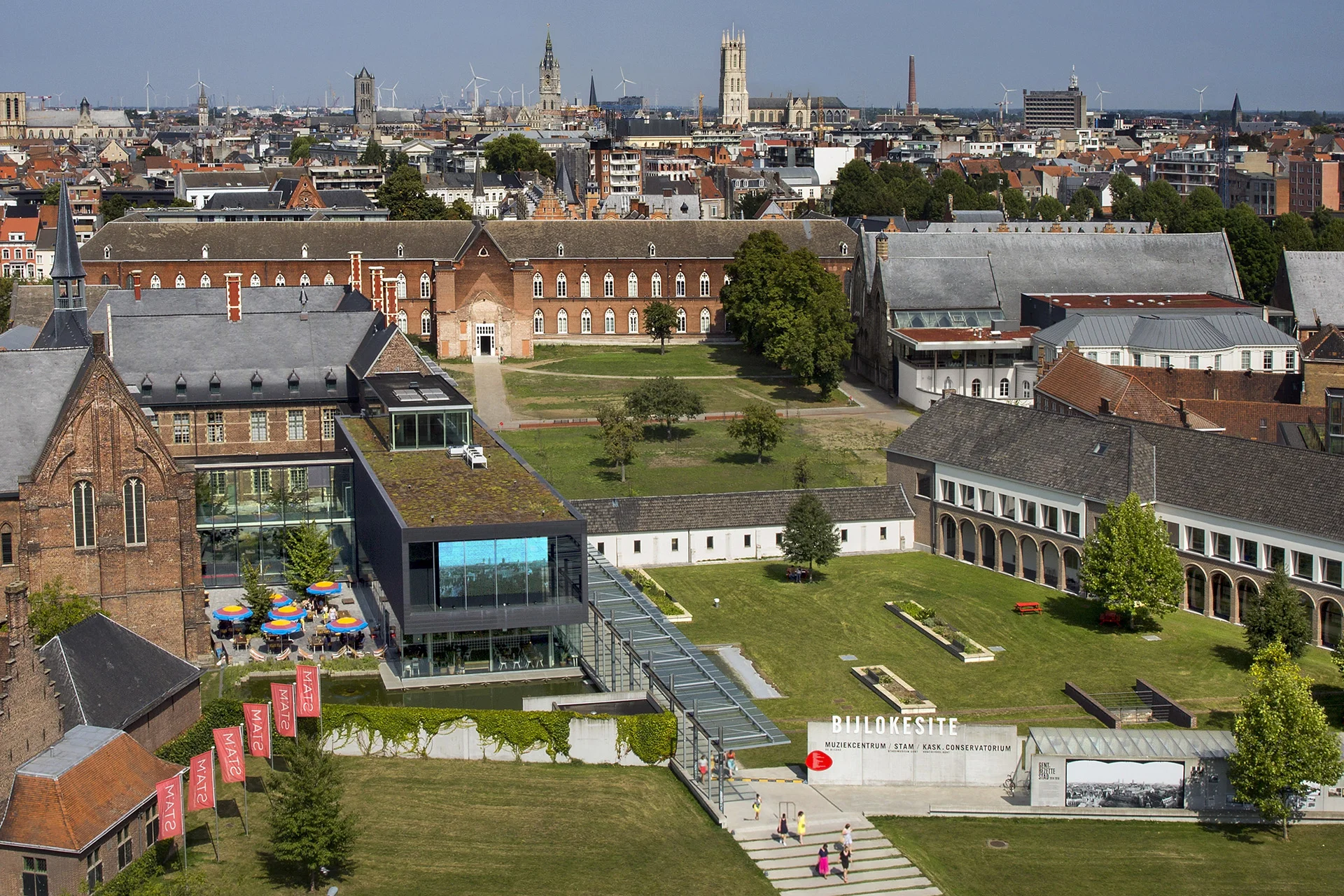 Aerial view of STAM City Museum in Ghent, showcasing historic buildings and green areas.