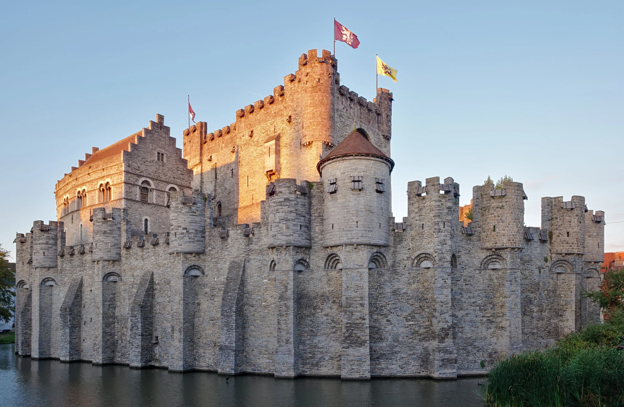 Gravensteen Castle glowing under the warm sunset light, a historic landmark in Ghent.