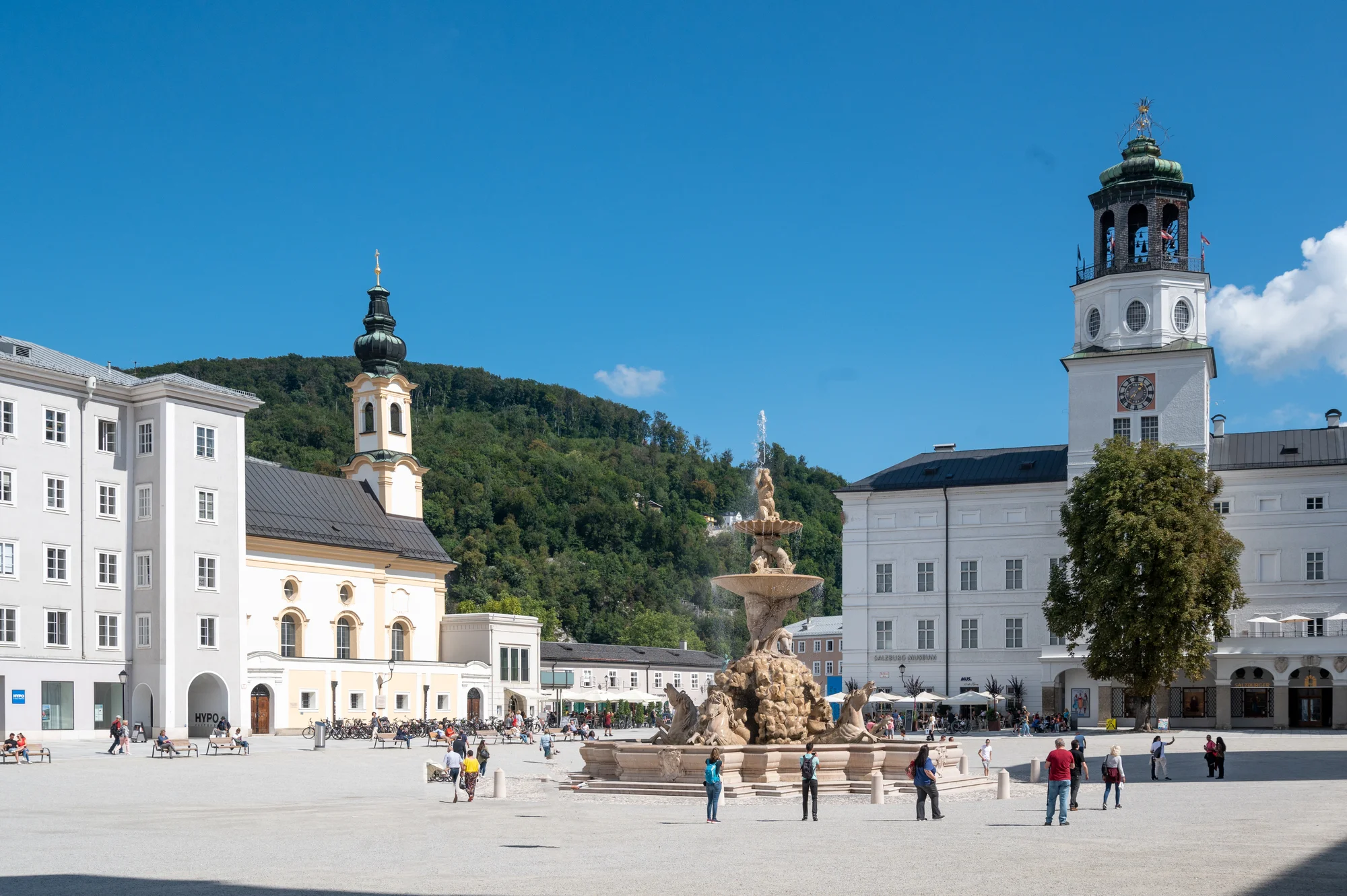 Residenzplatz in Salzburg, an iconic square with a spectacular fountain and historical buildings in the background.