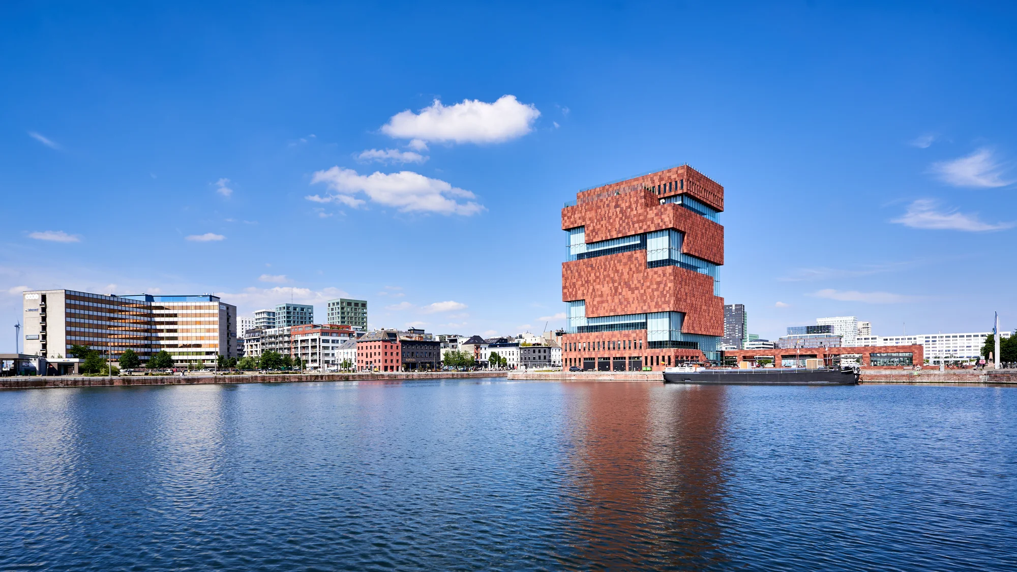 MAS Museum Antwerp - iconic building with its unique architecture reflected in water.