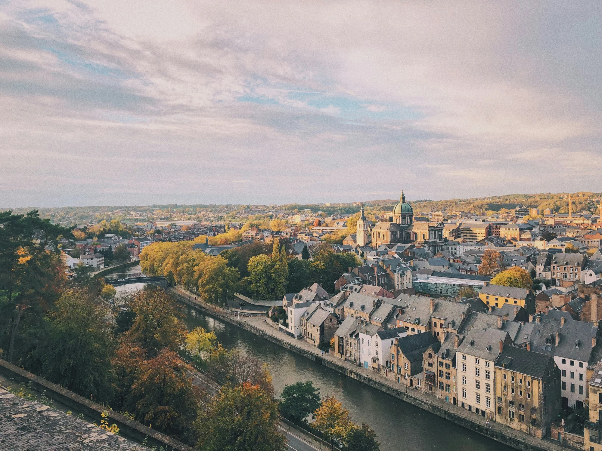 Panorama of Namur City, Belgium, featuring the Meuse River and historic buildings.
