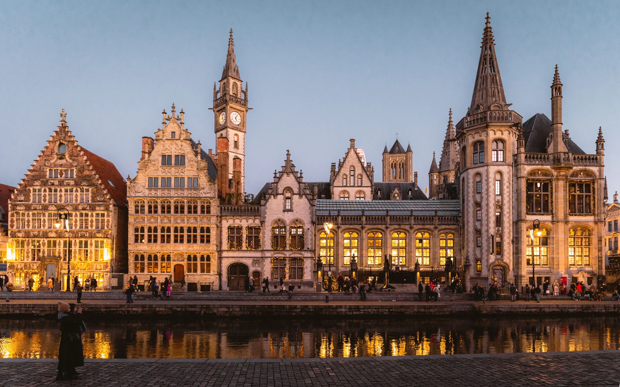Image of historic architecture lit up along the canal in Gent, Belgium.