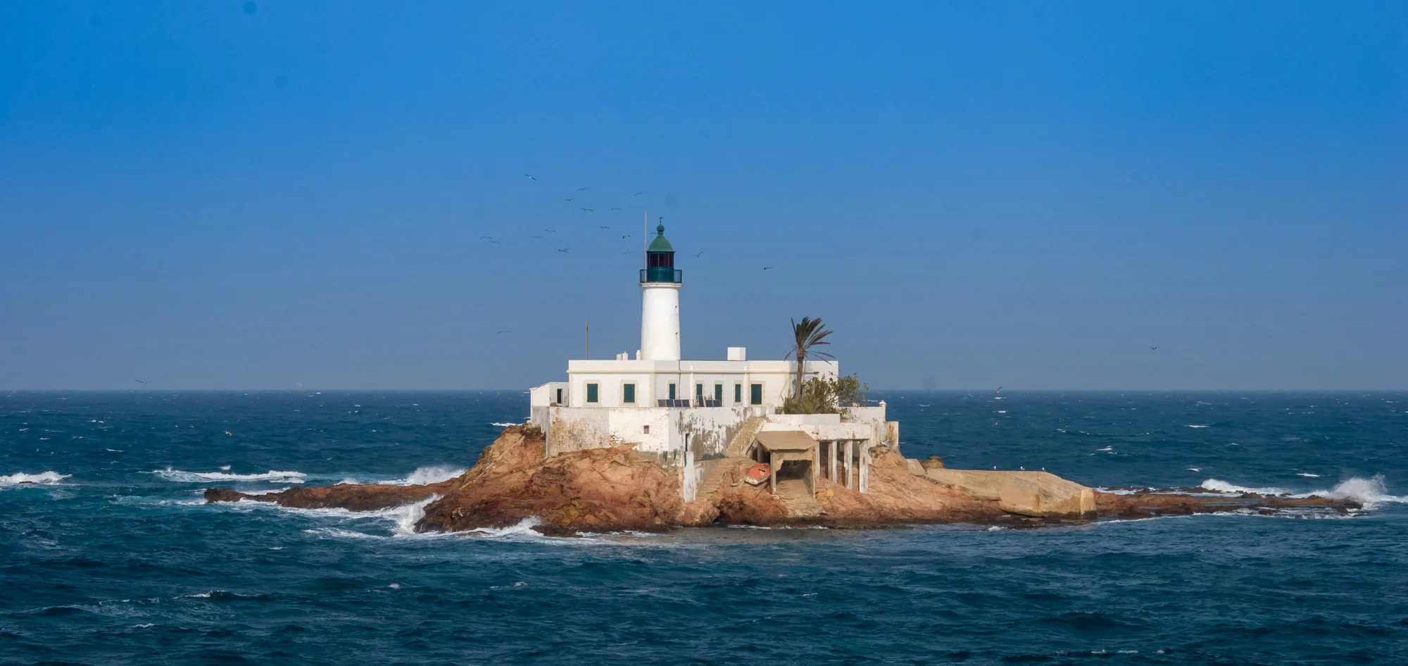 Santa Cruz Lighthouse in Oran, Algeria, on a small island surrounded by sea waves.