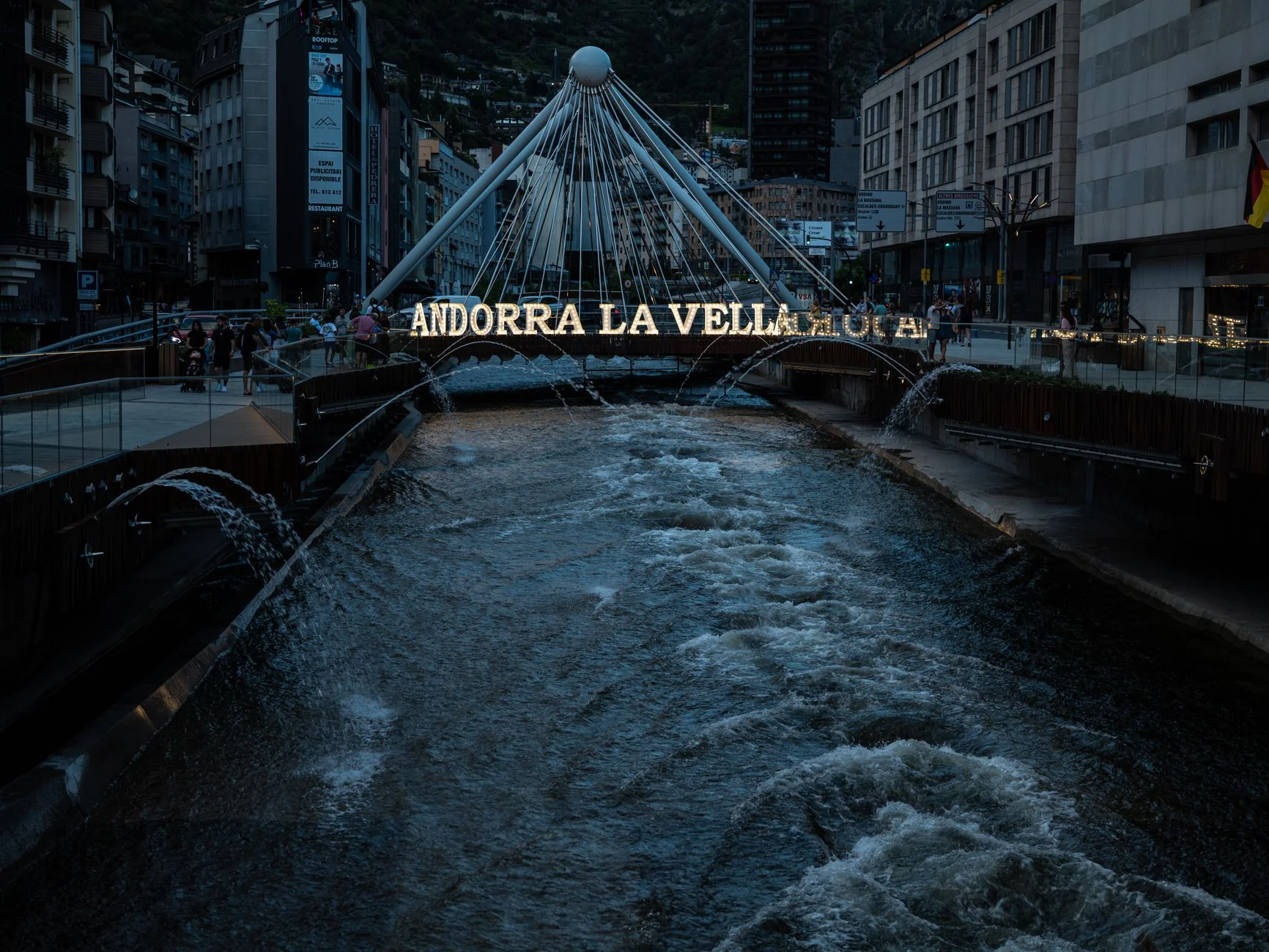Illuminated bridge over the Valira River at night in Andorra la Vella, Andorra.