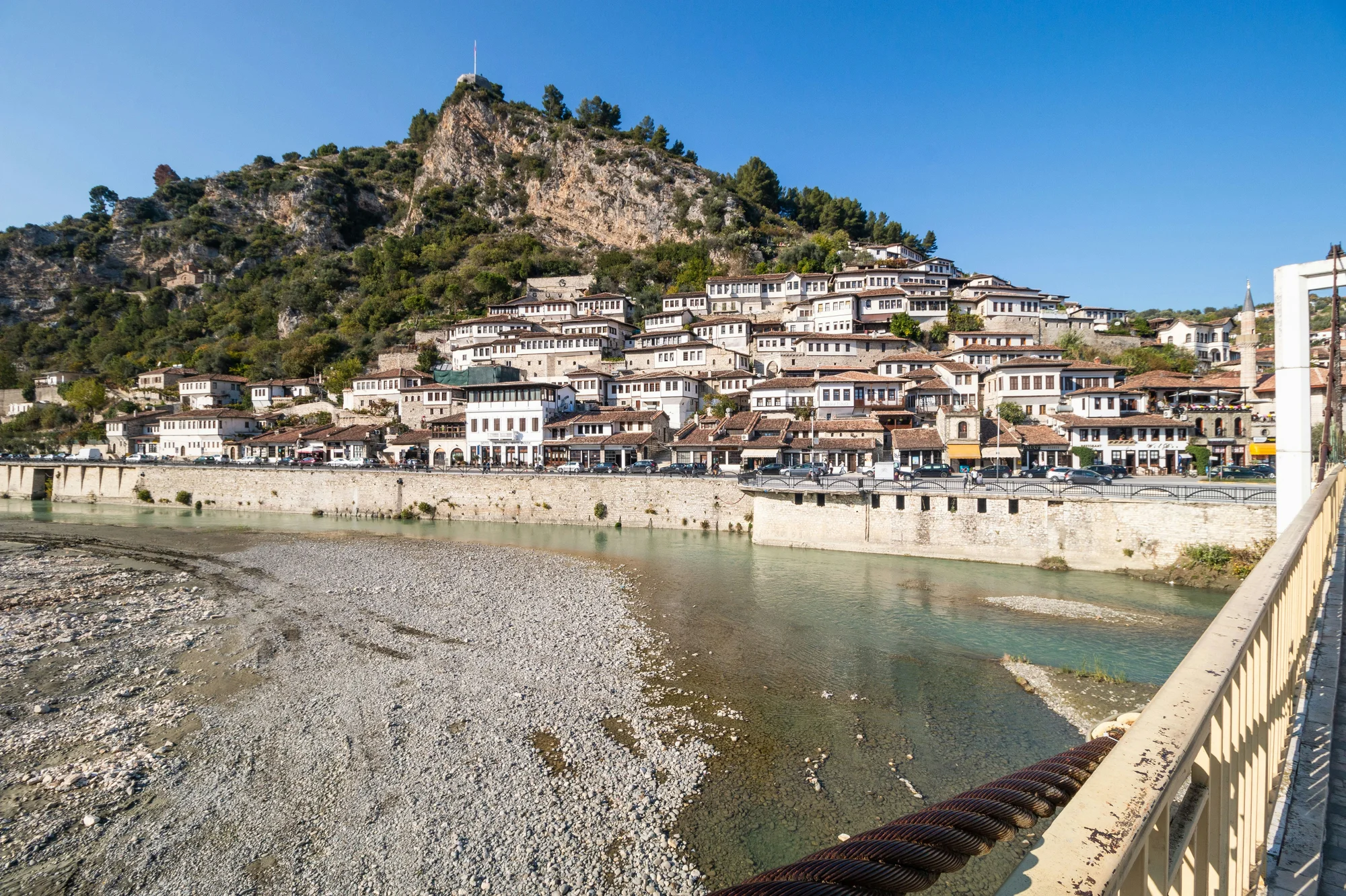 Traditional houses in Berat, Albania, the City of 1001 Windows, with the Osum River in the foreground.