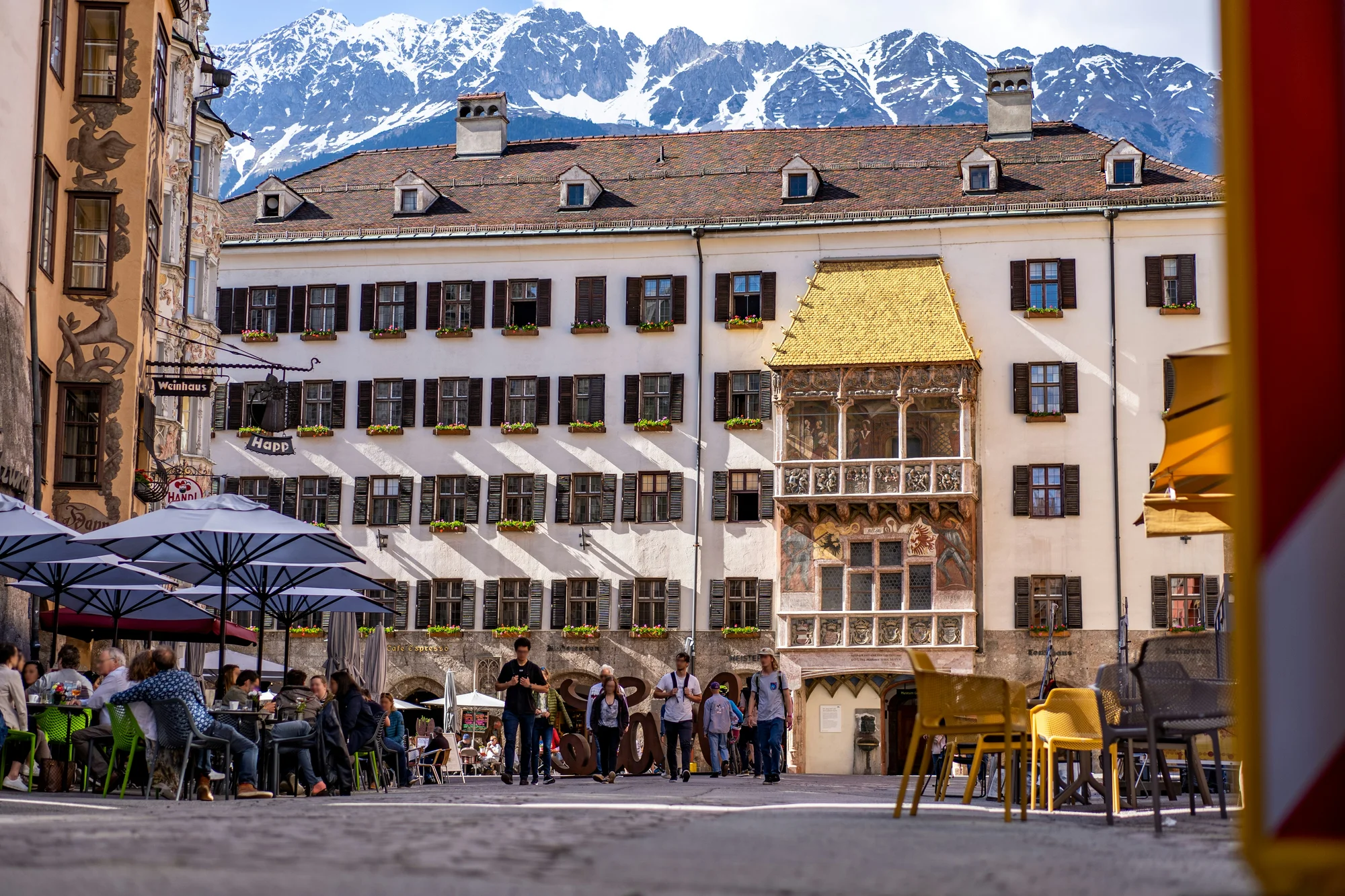 Golden Roof in Innsbruck with the Alps in the background, a famous tourist attraction.