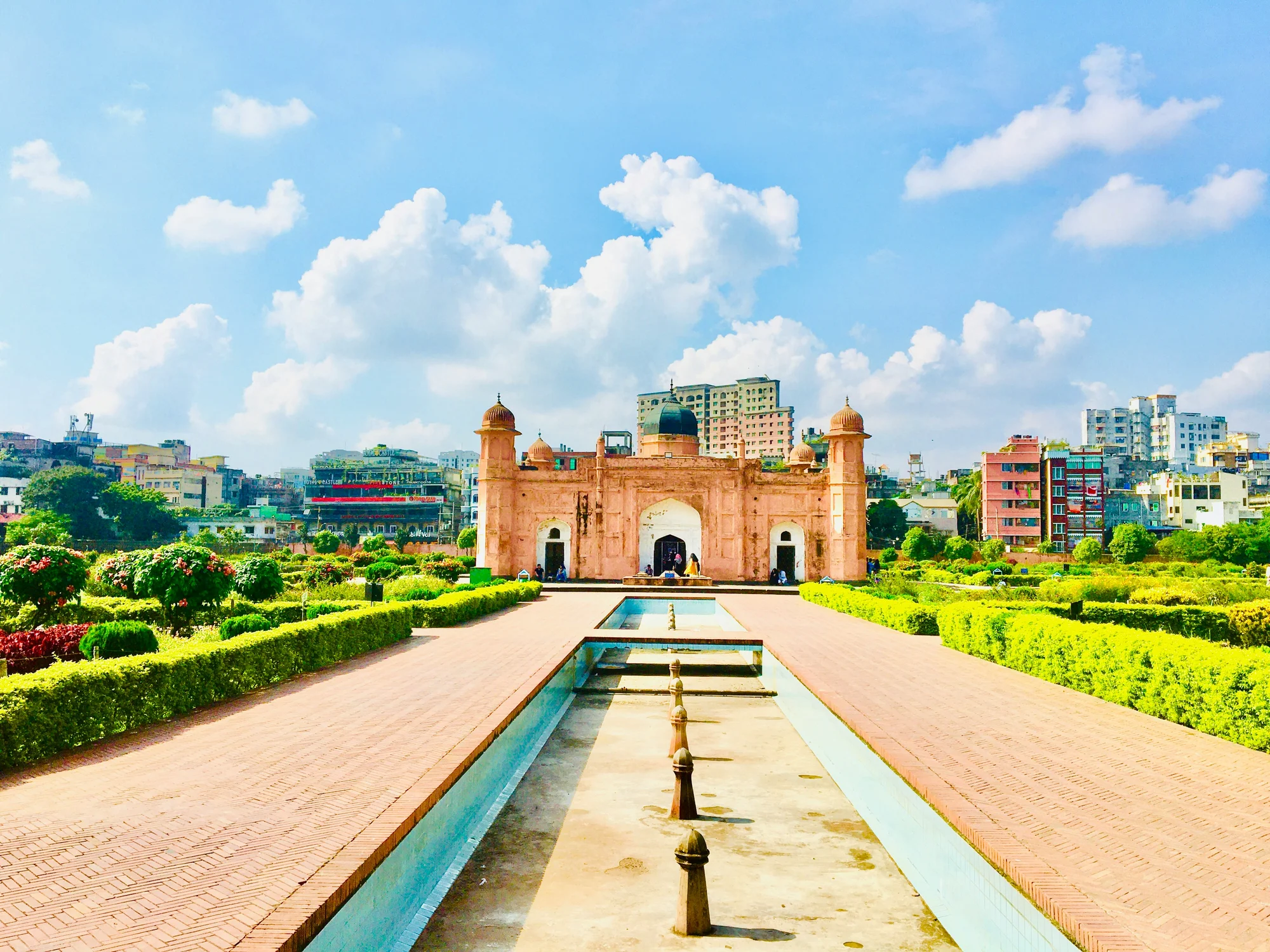 Lalbagh Fort in Dhaka with lush gardens and a blue sky.