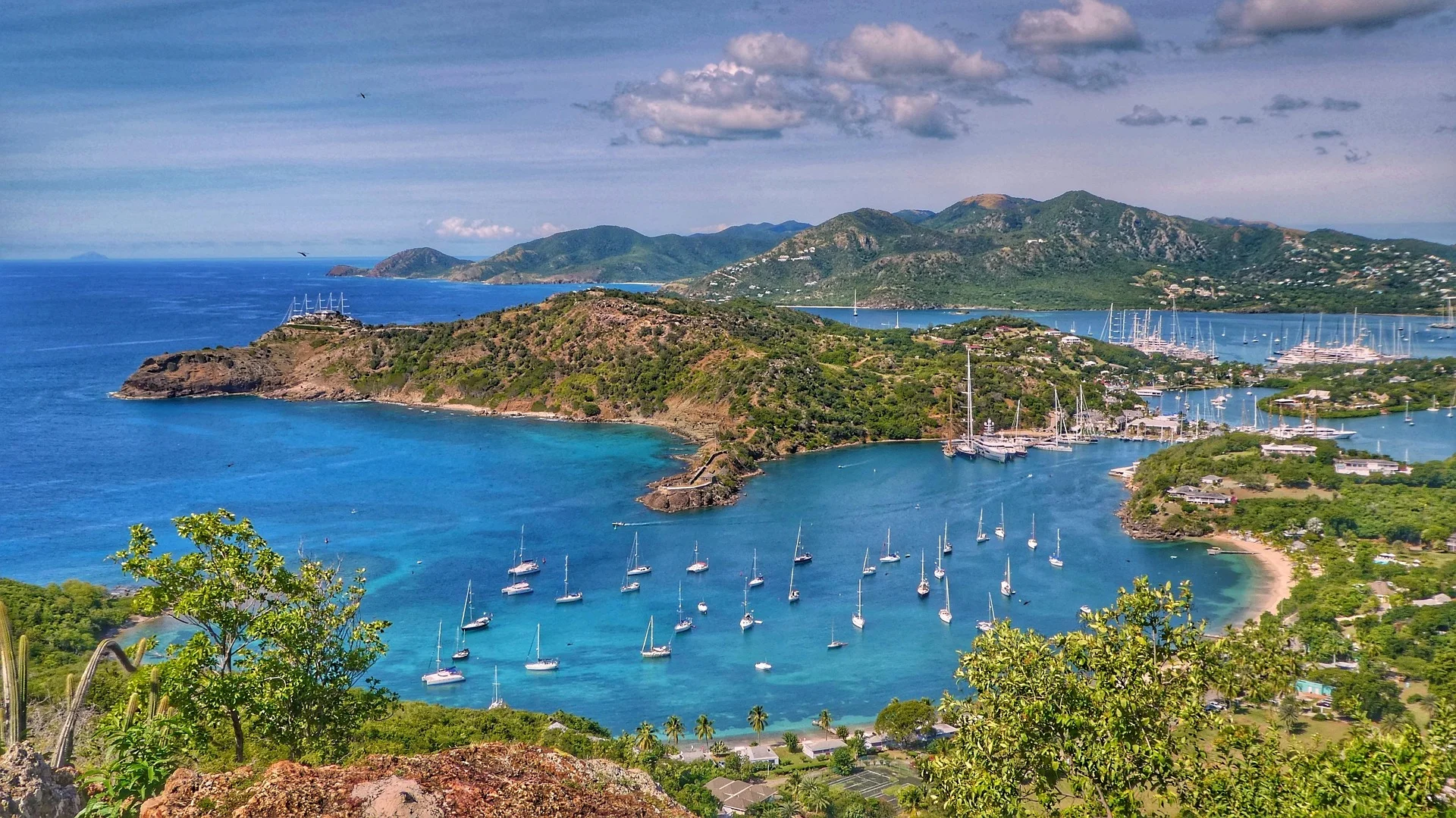 English Harbour in Antigua with yachts and mountainous backdrop.
