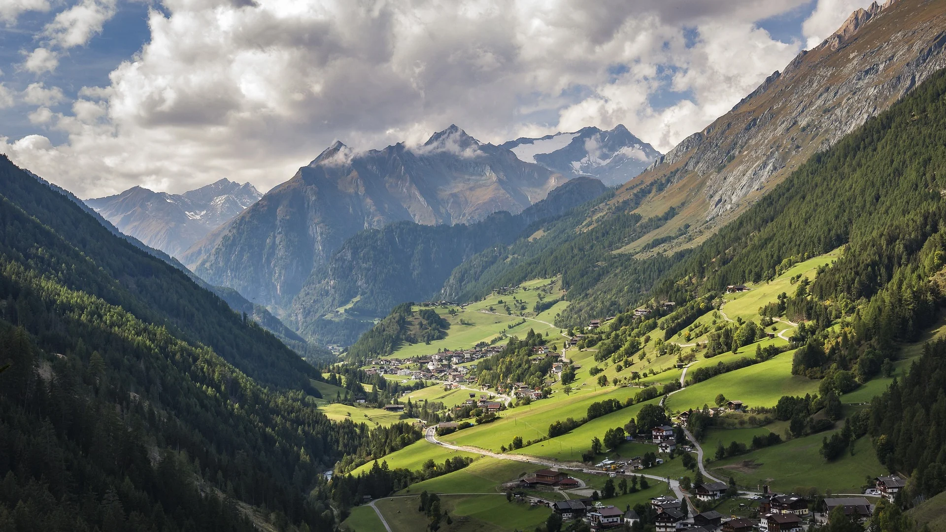 Alpine landscape in Tyrol, Austria, with mountain peaks and villages in the valley.